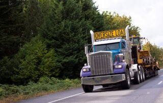truck with oversize load sign driving down the hallway